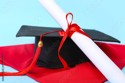 Mortar board and diploma on...