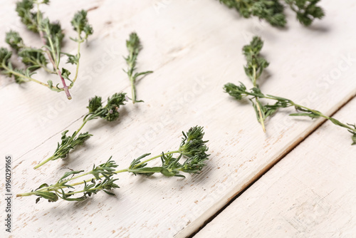 Fresh thyme on light wooden...