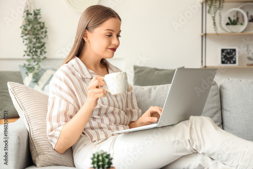 Young woman with laptop and...