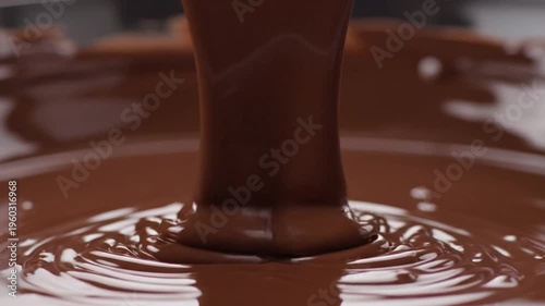 Fingers letting go of fine brown sand flowing between them in a relaxing macro moment