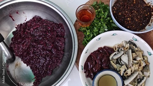 The focus is on selecting raw minced pork, slicing and preparing it on a wooden cutting board to make traditional Northern Thai-style larb.