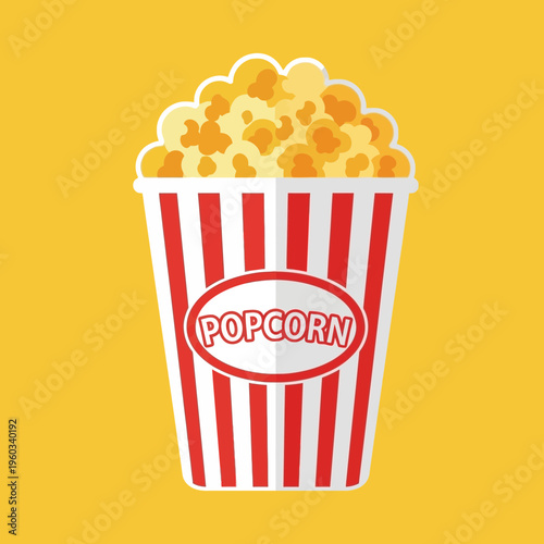 Colorful popcorn in striped bucket.