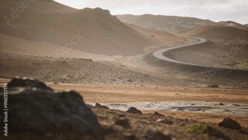 Winding road through vast desolate mountain landscape