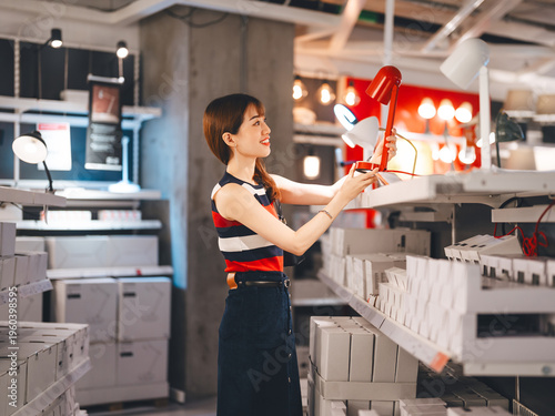 Konstfotografi Adult asian woman choosing lamp light product home interior shopping buying new