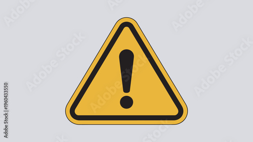 A yellow warning sign with a black exclamation mark on a gray background