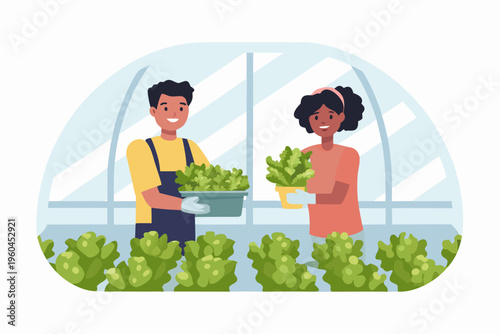 Two people tending to leafy green plants inside a greenhouse