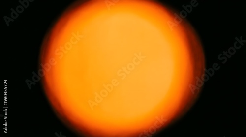 Blurred Orange Light Circle Glowing On A Dark Background With A Soft Warm Bokeh Effect