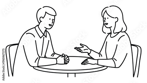Two people engaged in a friendly conversation at a table, ideal for illustrating communication, teamwork, or social interaction in business and casual settings