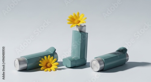 Three teal inhalers, one upright with yellow flowers, on light blue