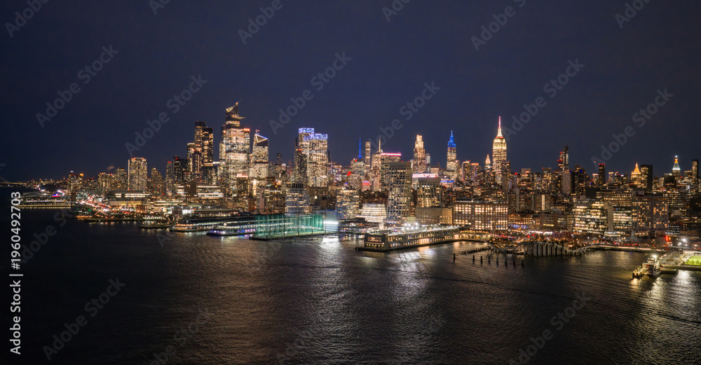 Fototapeta premium New York cityscape waterfront. NYC panoramic view of Lower Manhattan skyline. NewYork big American City. New York City at night. New York City aerial skyline. New York City downtown at night.