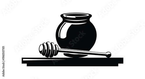 A striking black and white image depicting a honey jar with a dipper resting on a wooden surface silhouette