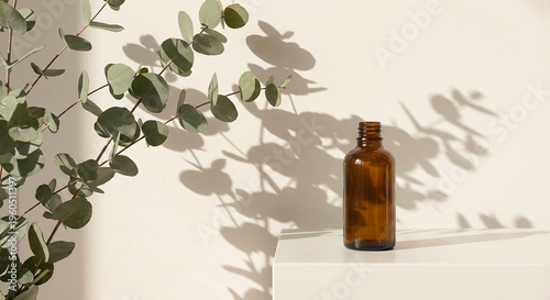 Amber glass dropper bottle with fresh eucalyptus on a beige surface perfect for an organic cosmetic concept and natural aromatherapy skincare mockup