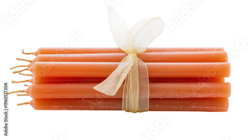 Fotografia Smooth peach taper candles bundled tied by a sheer cream ribbon, isolated on tra