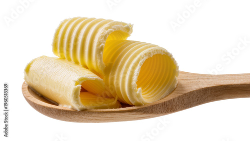 Foto Fresh golden butter curls resting on a textured wood spoon, isolated on transpar
