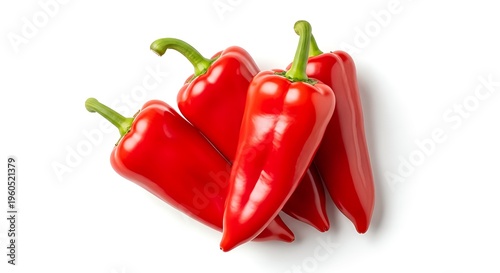 Vibrant red chili peppers stacked together on white background showcasing their glossy texture and green stems perfect for culinary or spice related concepts