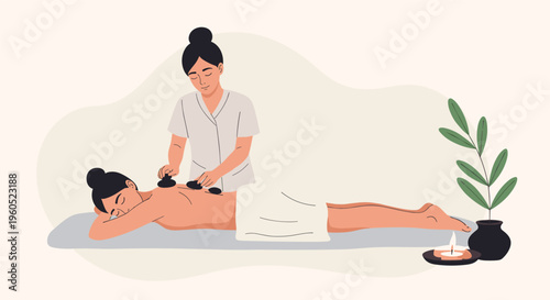 Young woman relaxing while receiving a professional hot stone massage treatment at a luxury spa and wellness center.