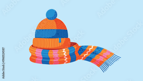 Warm winter set featuring an orange and blue striped knitted hat with a pom-pom and a matching long scarf.