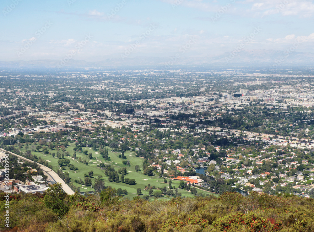 Obraz premium Skyline of Universal City as seen from the top of Cahuenga Peak at Wisdom Tree during a summer season in Los Angeles, California, USA