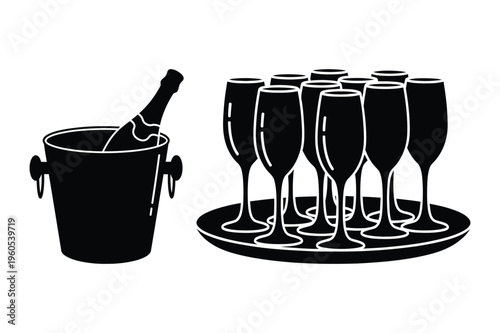 Champagne bottle in ice bucket with glasses