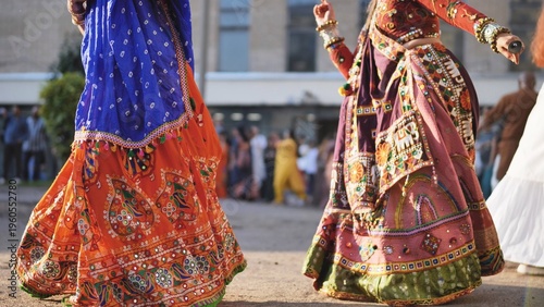 Celebrating Ganesh Chaturthi festival with people dancing Garba in vibrant Indian clothes