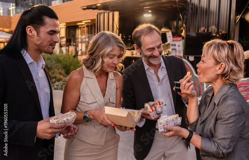 Business colleagues enjoying street food from a food truck