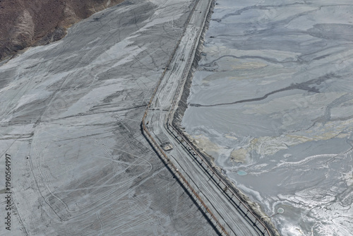 Принти на полотні Aerial view of a huge mining tailings dam next to a reservoir and storage tank