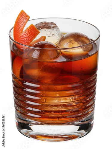 A glass of brown cocktail with ice and orange peel isolated on transparent background