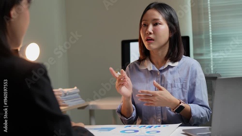 Asian businesswoman explaining company strategy in night meeting