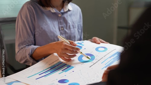 Businesswoman presenting financial data report during a meeting
