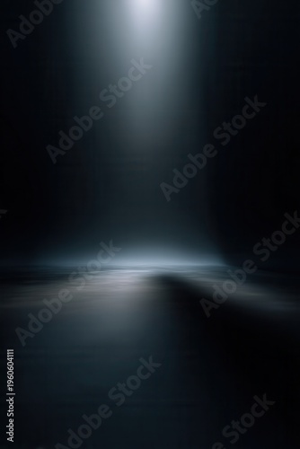Single spotlight illuminates misty, reflective floor