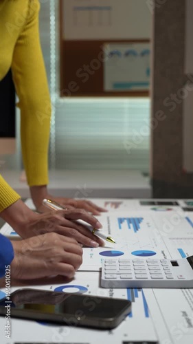 Business team analyzing financial data charts and graphs