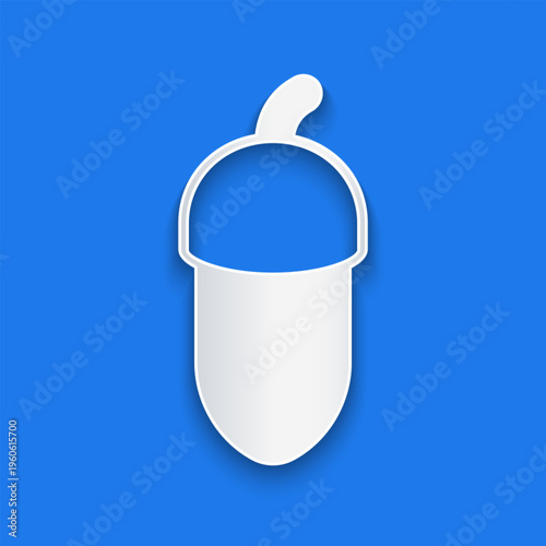Paper cut Acorn icon isolated on blue background. Paper art style. Vector