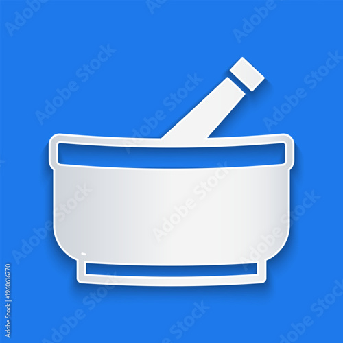 Paper cut Mortar and pestle icon isolated on blue background. Paper art style. Vector