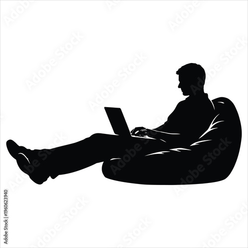 Man sitting on bean bag chair with laptop