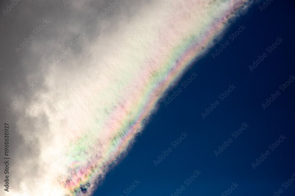 Fototapeta premium Rainbow in the blue sky with clouds