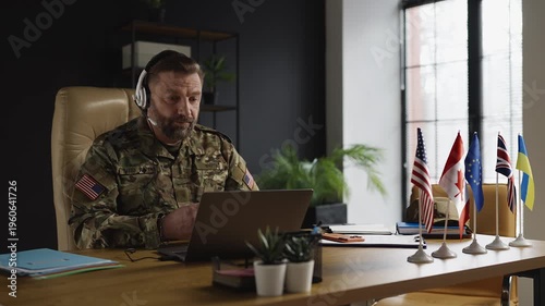 U.S. military attache in headset has video call with international partners