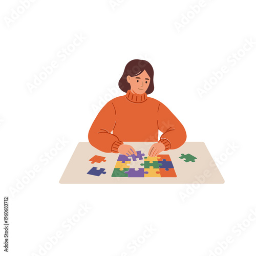 Woman sitting at a table assembling a colorful jigsaw puzzle with pieces