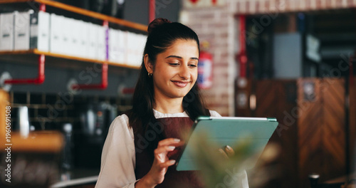 Fotografie Planning, happy and woman on tablet in restaurant for online inventory, website and orders
