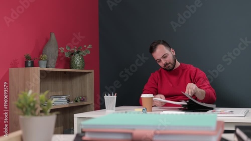 Professional businessman reading important office documents at his desk
