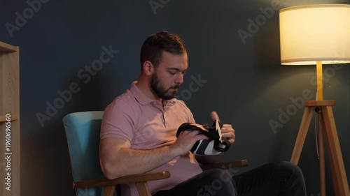 Man putting on vr headset exploring metaverse at home