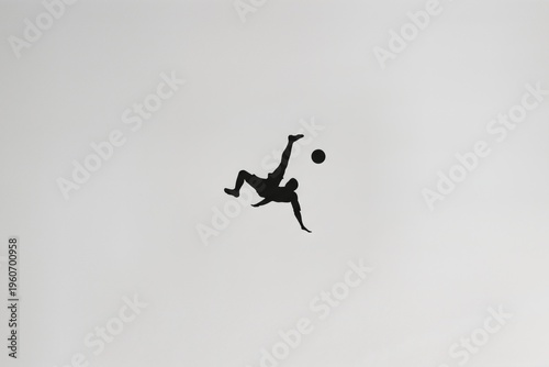 Silhouette of a Person Executing a Bicycle Kick in the Sky with a Soccer Ball Above