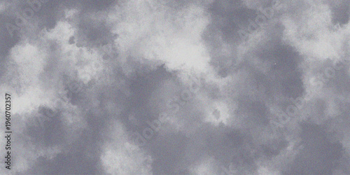 Gray cloudy sky with white clouds on a textured background.