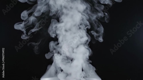 White smoke billows upwards against a dark background