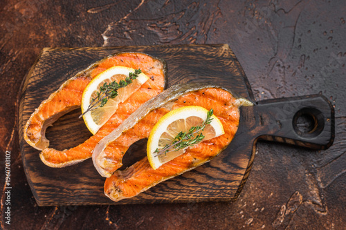 Tableau sur toile Closeup grilled salmon steaks chum  with juicy texture and char marks, thyme and