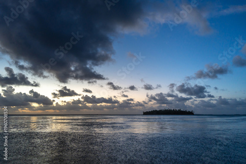 Sunset over a tropical motu on Tikehau Atoll, French Polynesia