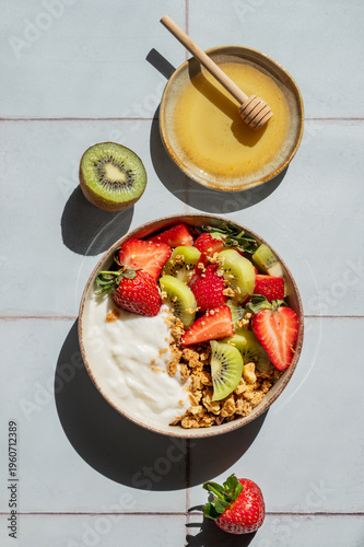 Balanced breakfast with yogurt, granola and fruits, top view