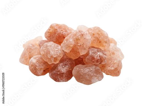 Pink Himalayan rock salt crystals sit in a small heap with an isolated transparent background image
