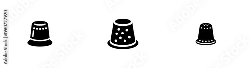 A vintage, classic sewing thimble with a dimpled texture and side profile.