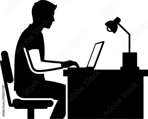 Man working on laptop at desk with lamp in office