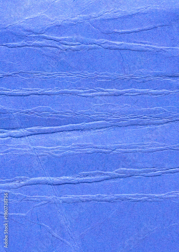 Blue crumpled wrinkled paper background or backdrop with fine details and texture with copy space for text design element